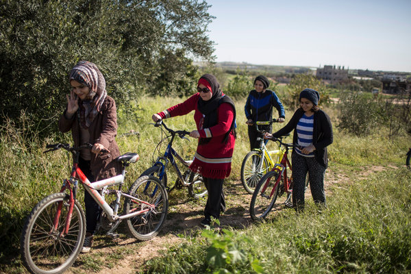 "Ms. Suleiman, center, and other women with their bikes in Gaza on Friday." in http://www.postnewsreport.com/in-gaza-bicycles-are-a-battleground-for-women-who-dare-to-ride/